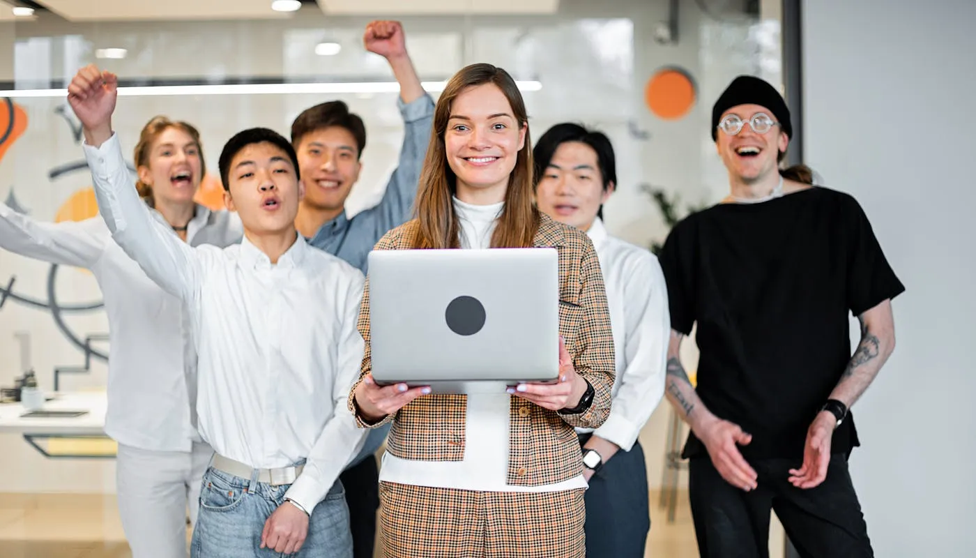Diverse team celebrating success in a modern workspace