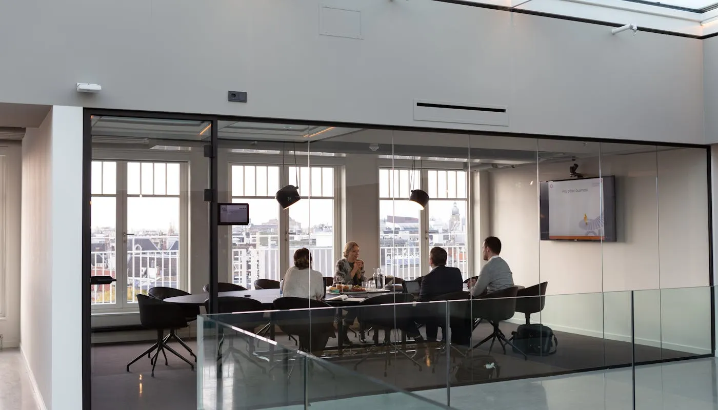 Professional meeting in a modern glass-walled office